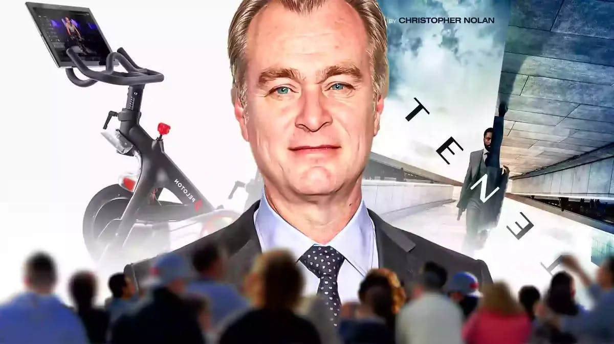 Christopher Nolan with Peloton bike and Tenet poster.