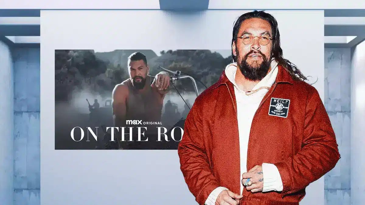 Jason Momoa in front of On the Road poster.