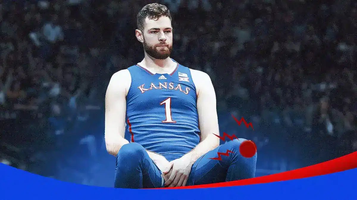 ACTION SHOT of Hunter Dickinson (Kansas basketball star) with red pain symbol on his knee