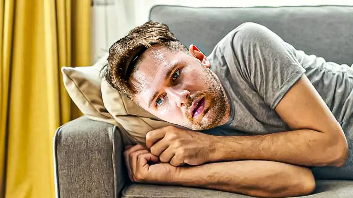 Mavericks' Luka Doncic lying on a couch looking sad
