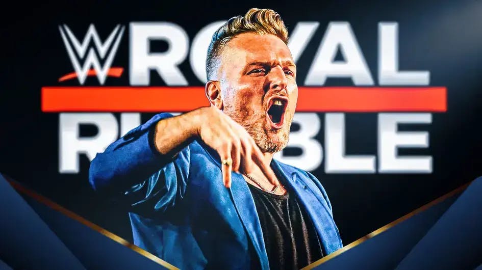Pat McAfee in front of the Royal Rumble logo.