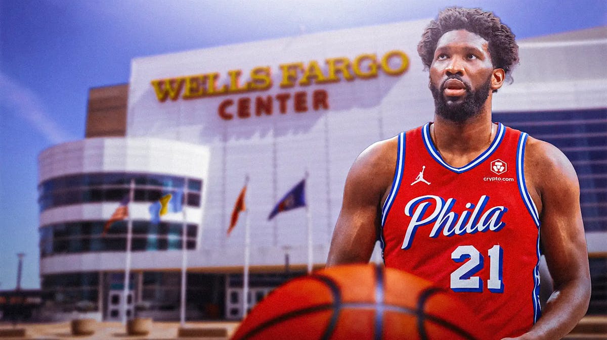 Joel Embiid with the Sixers arena in the background