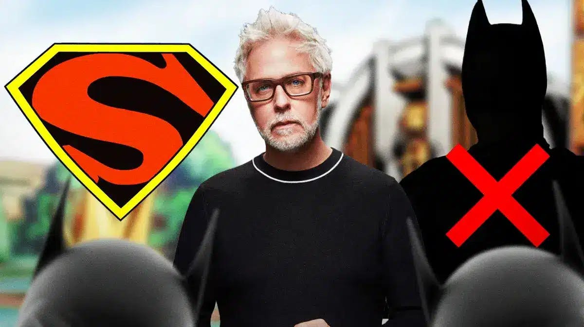 James Gunn in between a Superman logo and silhouette of Batman with a red X over it