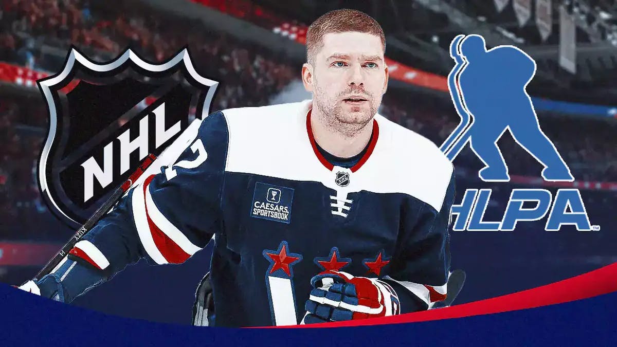 Capitals' Evgeny Kuznetsov stands next to NHL and NHLPA logos