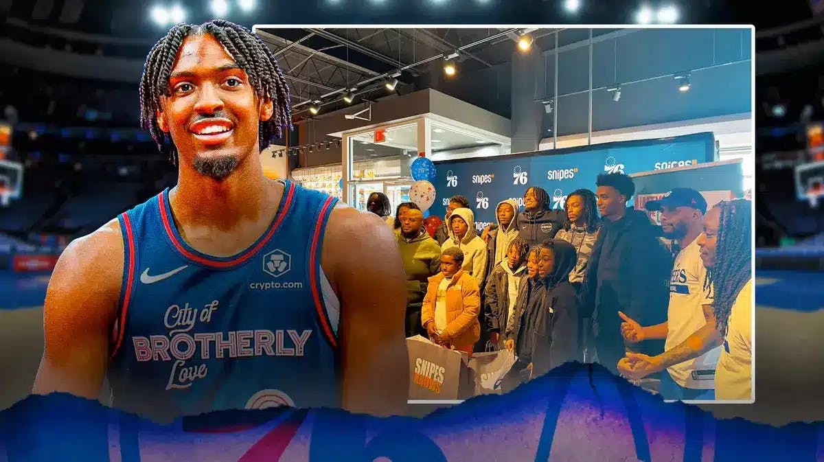 76ers' Tyrese Maxey next to a picture of his charity event at SNIPES in Philadelphia