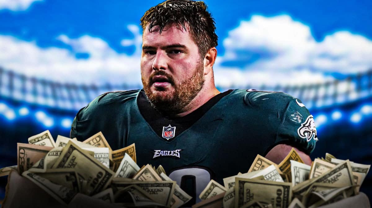 Eagles guard Landon Dickerson with stacks of cash next to him