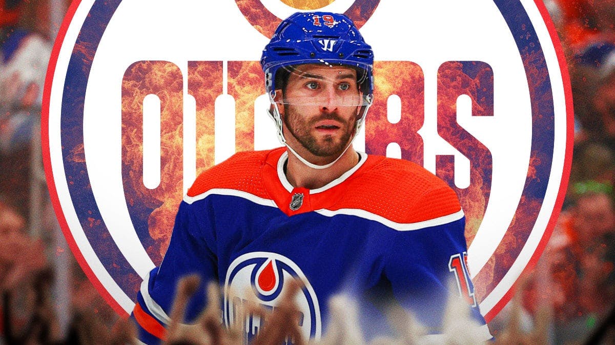 Adam Henrique in image looking happy with fire around him, Edmonton Oilers logo, hockey rink in background