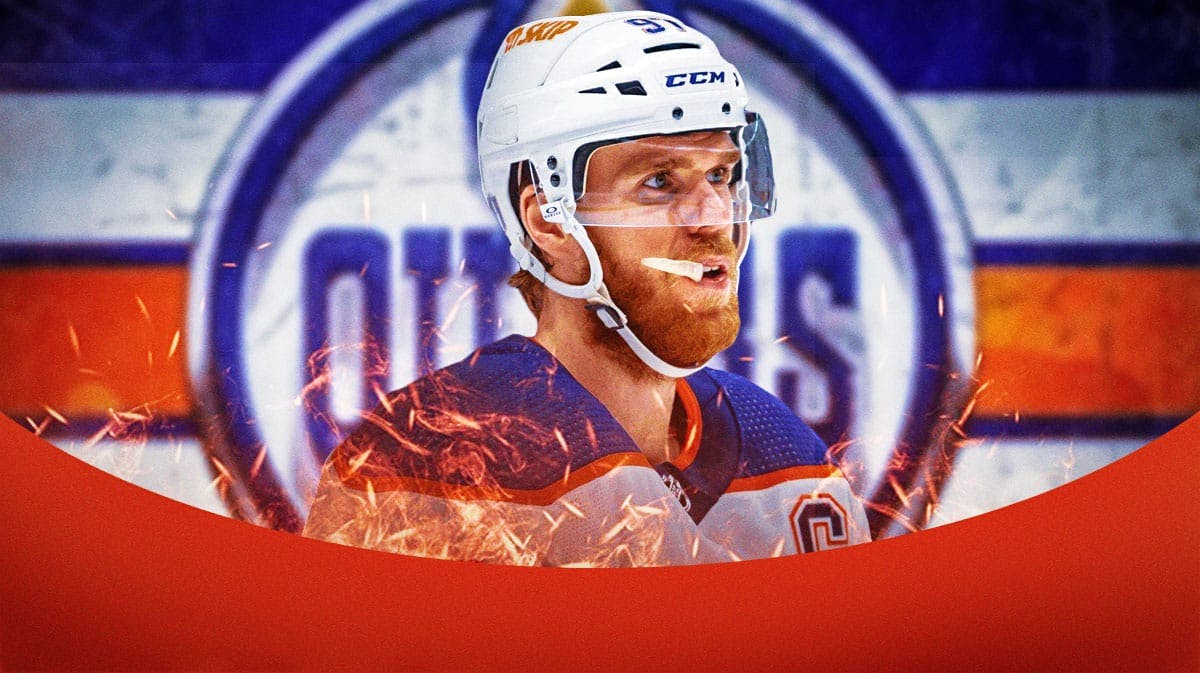 Connor McDavid in middle of image looking happy with fire around him, Edmonton Oilers logo, hockey rink in background