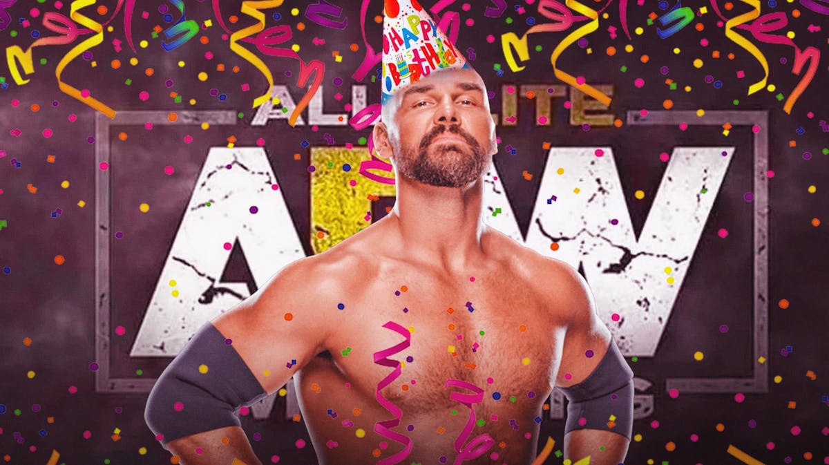 Dax Harwood wearing a birthday hat with streamers around him and the AEW logo as the background.