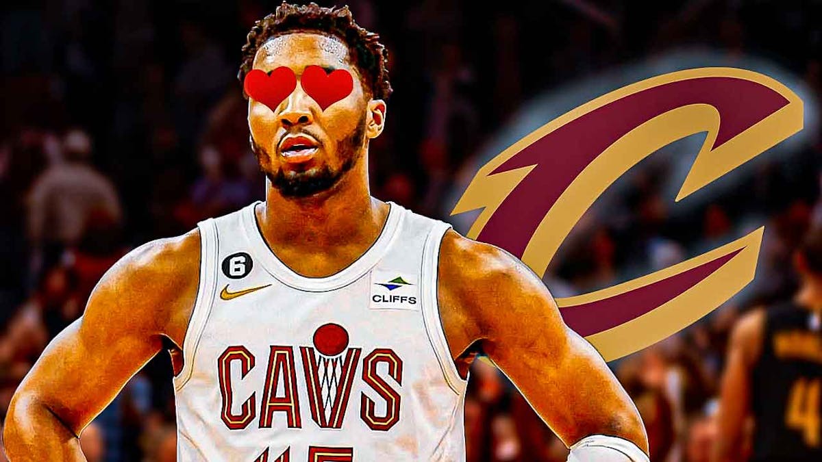 Donovan Mitchell with hearts in place of his eyes looking at a glowing Cavs logo