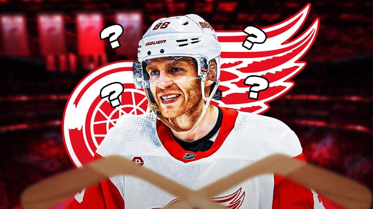 Patrick Kane in middle of image looking happy, Detroit Red Wings logo, 3-5 question marks in background, hockey rink in background