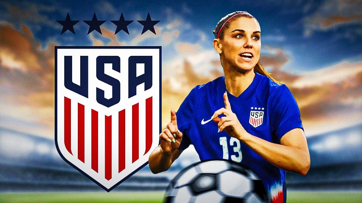 Alex Morgan smiling in front of the USWNT logo