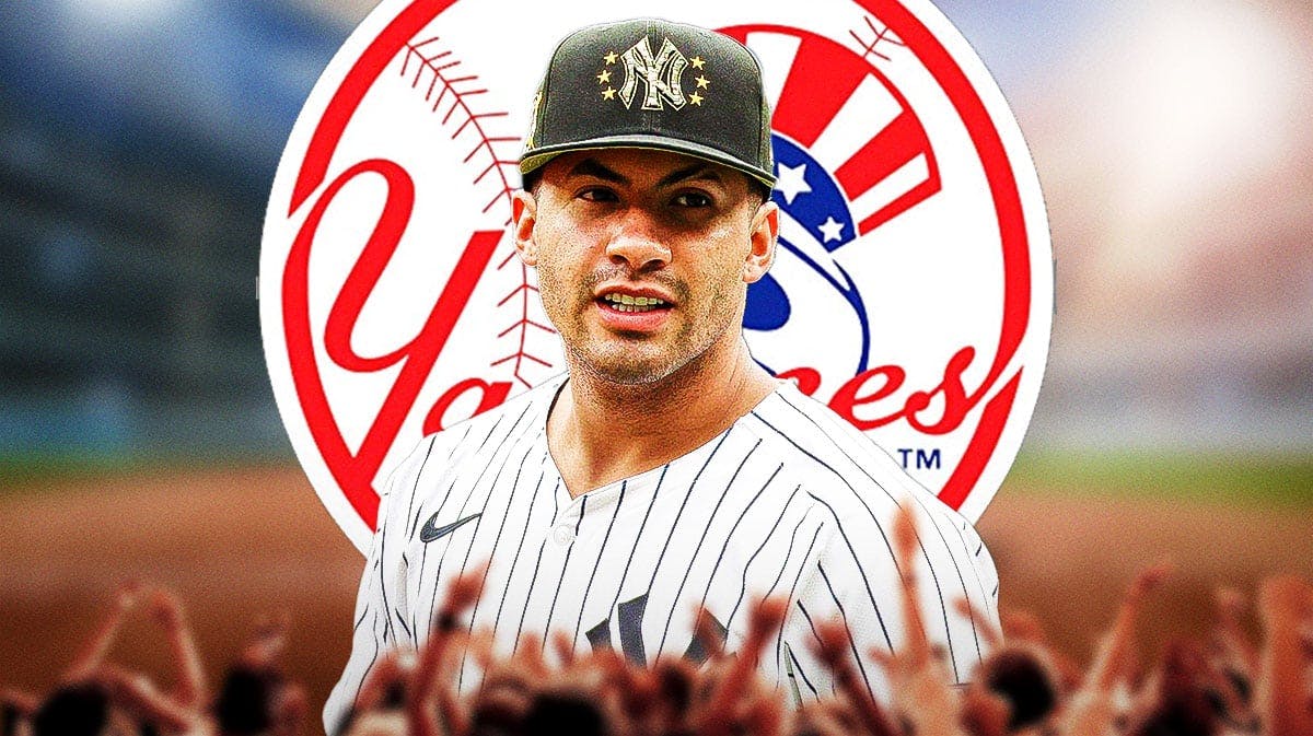 Gleyber Torres in front of a Yankees logo