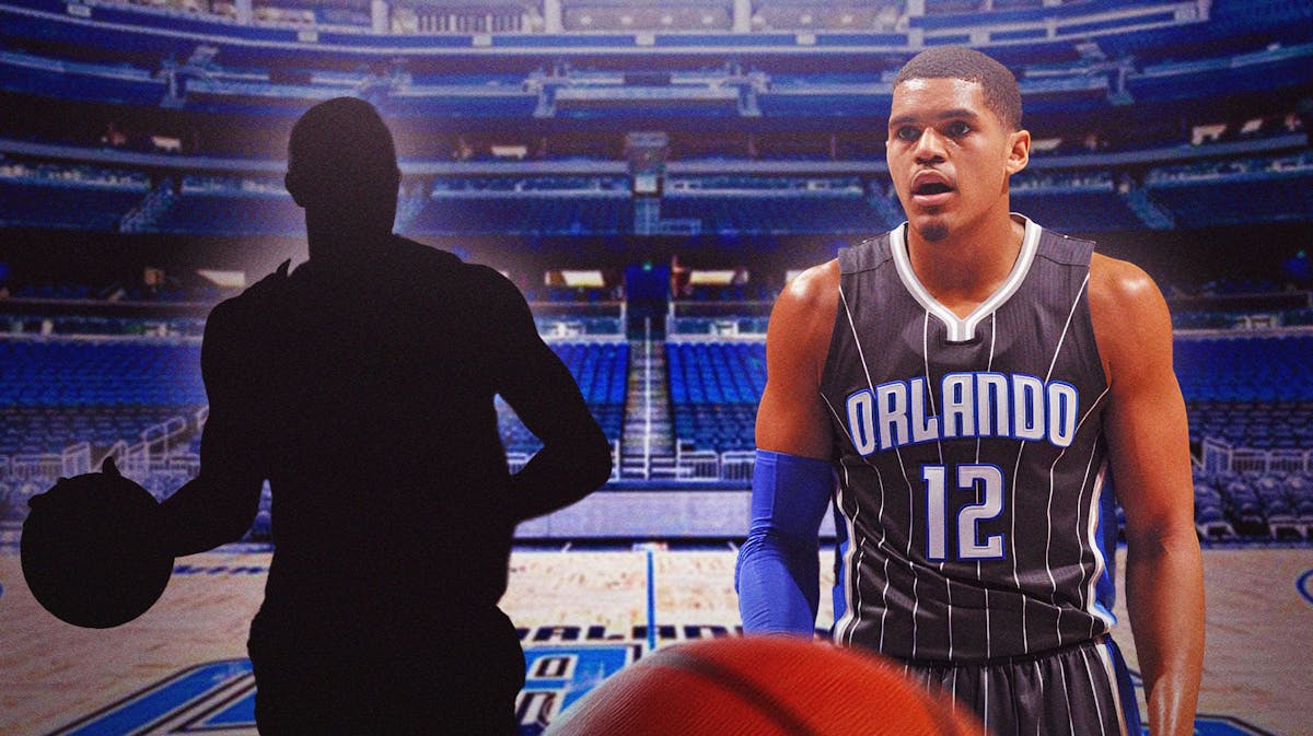 Tobias Harris in his Orlando Magic uniform with the blacked-out silhouette of DeMar DeRozan in the Orlando Magic's arena.