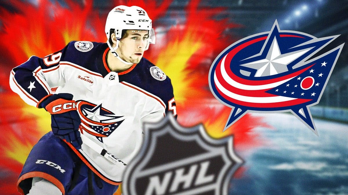 Yegor Chinakhov in middle of image looking happy with fire around him, Columbus Blue Jackets logo, hockey rink in background
