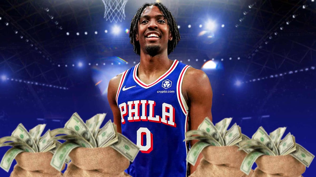 76ers' Tyrese Maxey next to bags of money