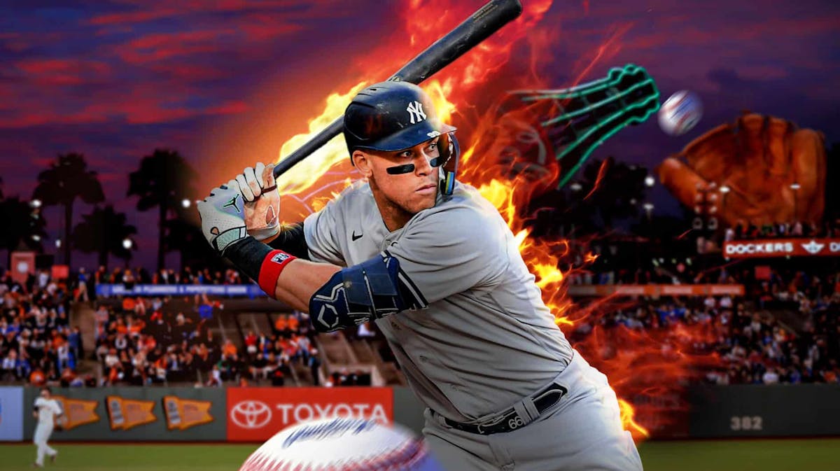 Aaron Judge swinging a bat with fire coming off of him. Oracle park in the background.