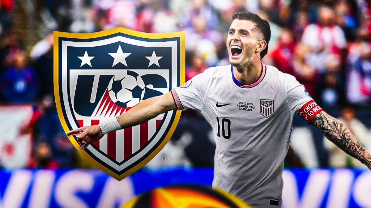 Christian Pulisic celebrating in front of the USMNT logo