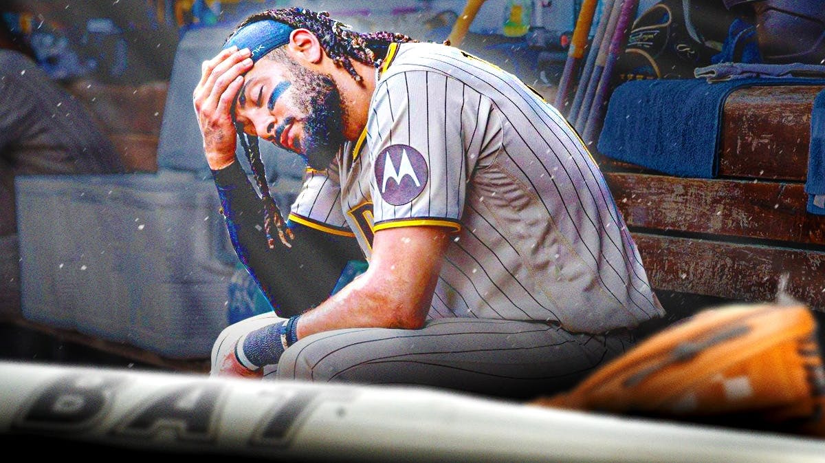 Padres Fernando Tatis Jr. sitting in an MLB dugout looking upset/serious.