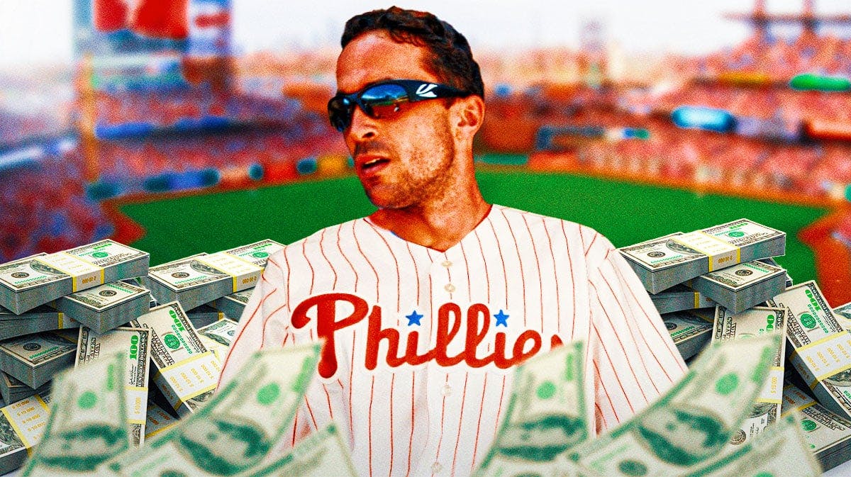 Phillies GM Sam Fuld smiles with bags of money around him