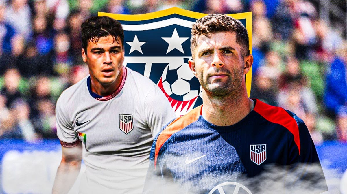 Gio Reyna and Christian Pulisic looking down/sad in front of the USMNT logo