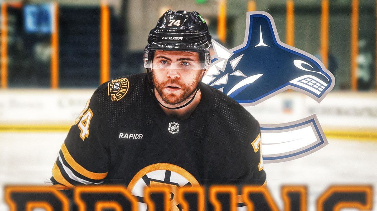 Jake DeBrusk in image looking stern, Vancouver Canucks logo, hockey rink in background