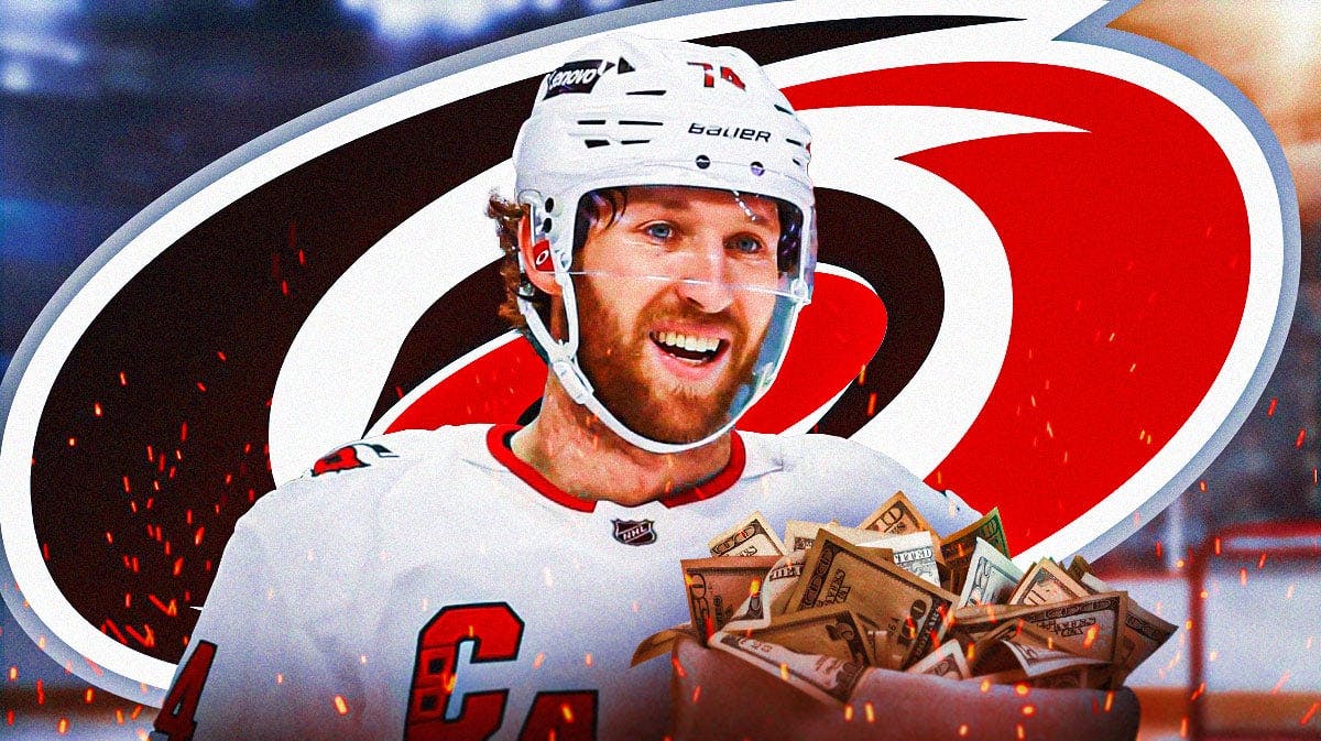 Jaccob Slavin in image looking happy with fire around him and money in image, Carolina Hurricanes logo, hockey rink in background