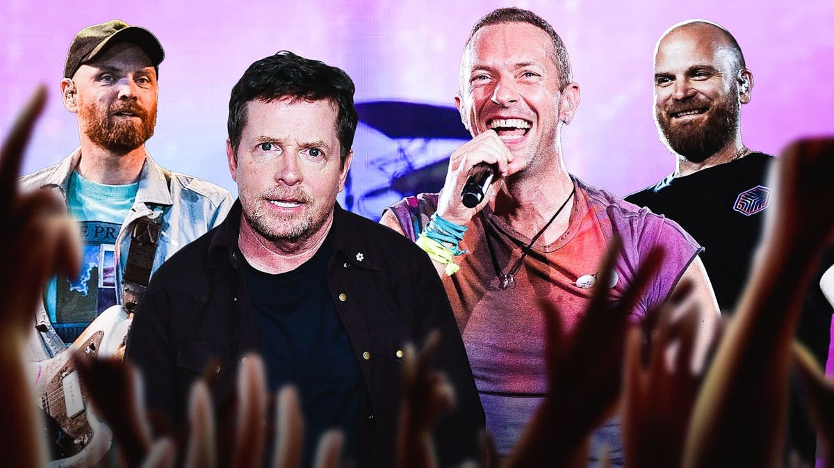 Coldplay members Will Champion, Chris Martin, and Jonny Buckland with Michael J. Fox in front of Glastonbury background.