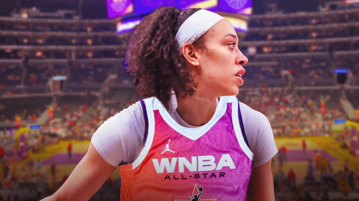 Dearica Hamby in a 2024 WNBA All-Star jersey with the LA Sparks arena in the background