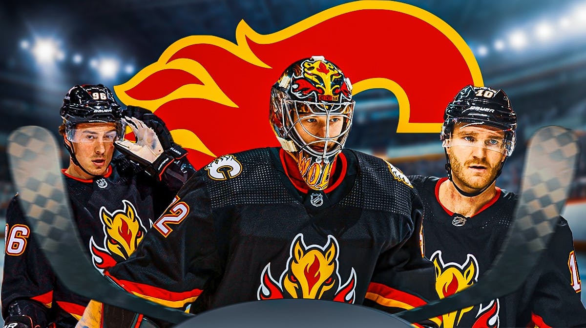Dustin Wolf in middle, Jonathan Huberdeau and Andrei Kuzmenko on either side, Calgary Flames logo, hockey rink in background