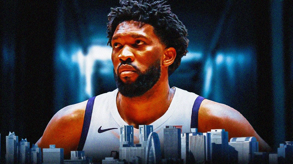 76ers Joel Embiid looking serious in front. Close-up image. Have him in a dark room.