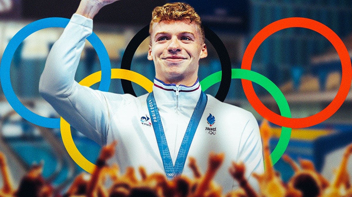 Team France's Leon Marchand waves to crowd after swimming in 2024 Olympic 200m