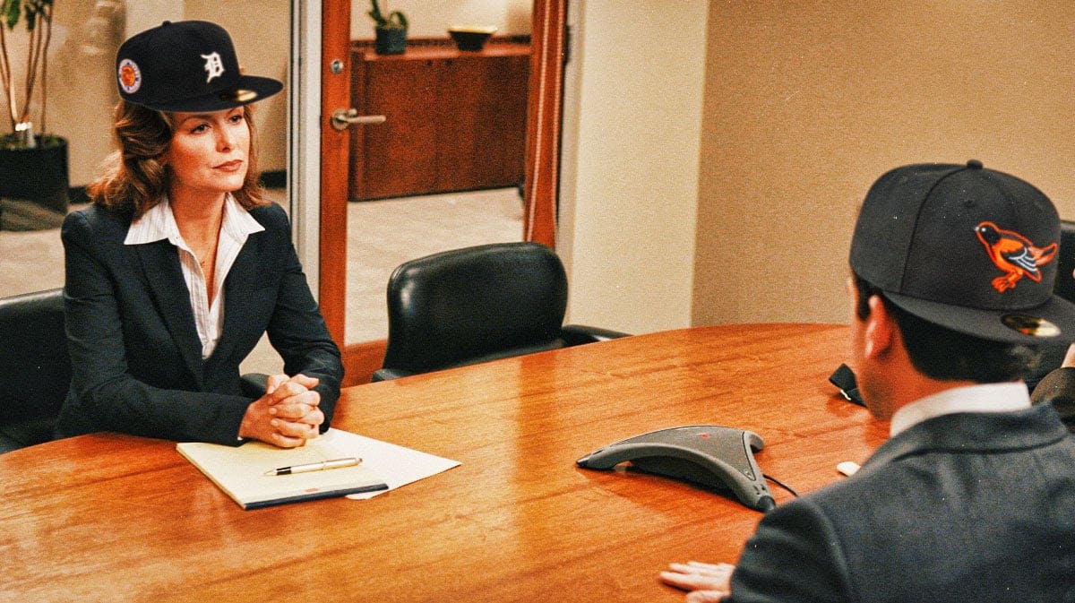 Jen of The Office wearing a Detroit Tigers cap, Michael Scott wearing a Baltimore Orioles cap