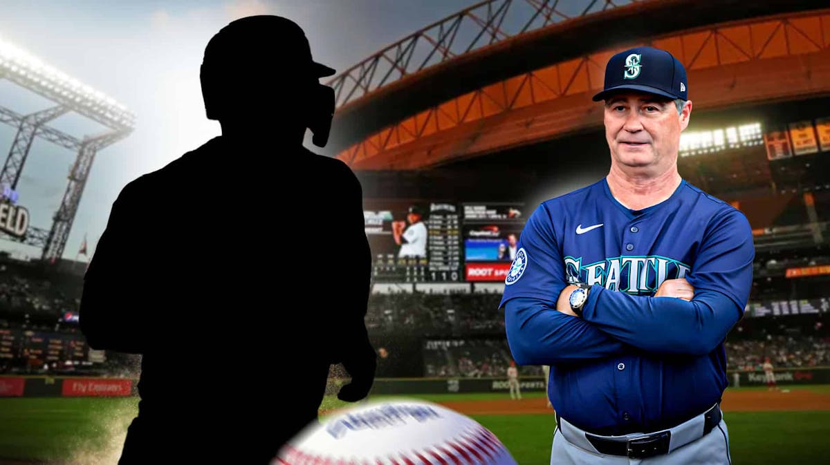 Scott Servais with arms crossed standing next to silhouette of Ty France