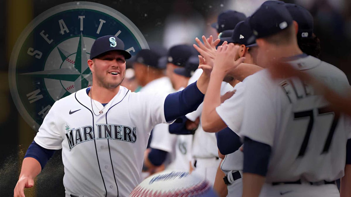 Ty France in a Seattle Mariners uniform celebrating, looking happy or high fiving/celebrating with another Mariners teammate as he remembers the Wild Card postseason the Mariners got in 2022.
