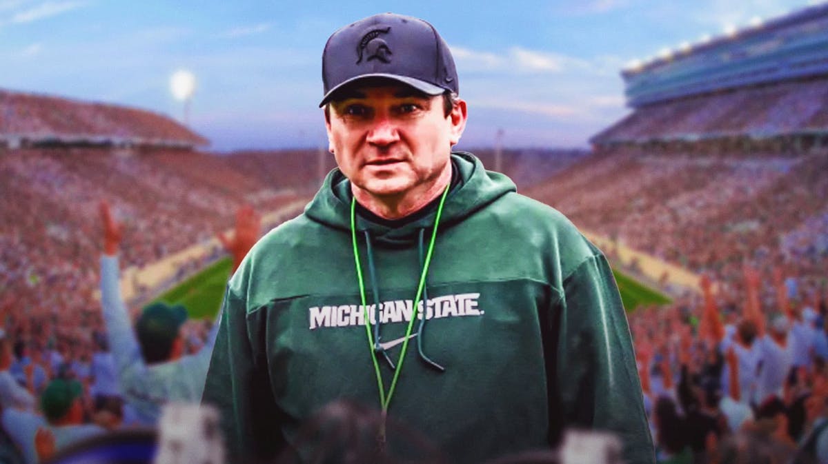 Michigan State football, Spartans, Jonathan Smith, 2024 Michigan State football, Michigan State football predictions, Jonathan Smith in Michigan State gear with Michigan State football stadium in the background