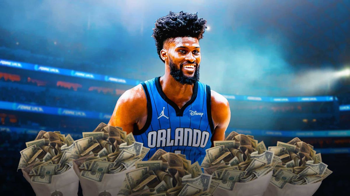 Jonathan Isaac smiles with money bags around him