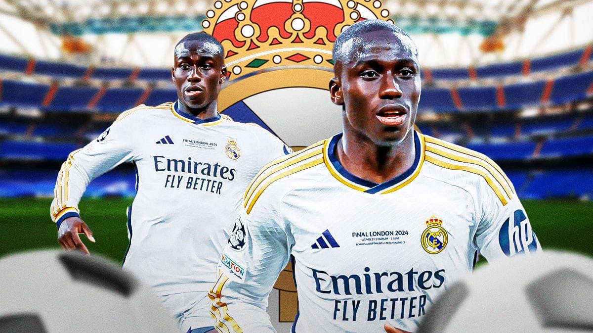 Ferland Mendy in front of the Real Madrid logo