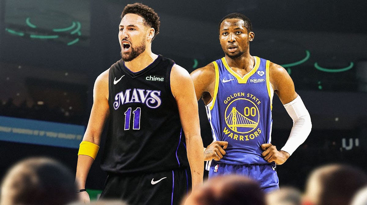 Jonathan Kuminga alongside Klay Thompson in his Dallas Mavericks jersey with the Golden State Warriors arena in the background