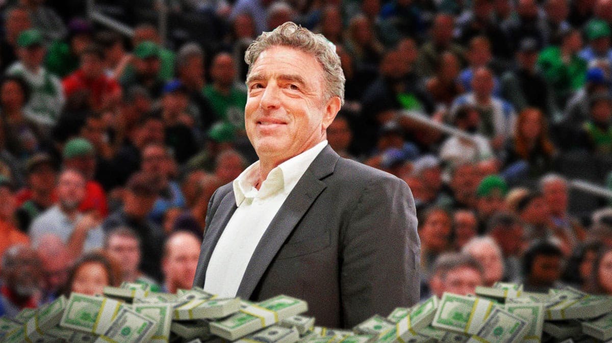 Wyc Grousbeck surrounded by piles of cash.