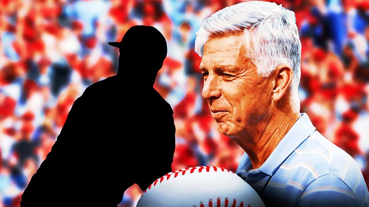 Philadelphia Phillies president of baseball operations Dave Dombrowski smiling - Silhouette of Miami Marlins pitcher Tanner Scott next to him - Phillies fans cheering in background