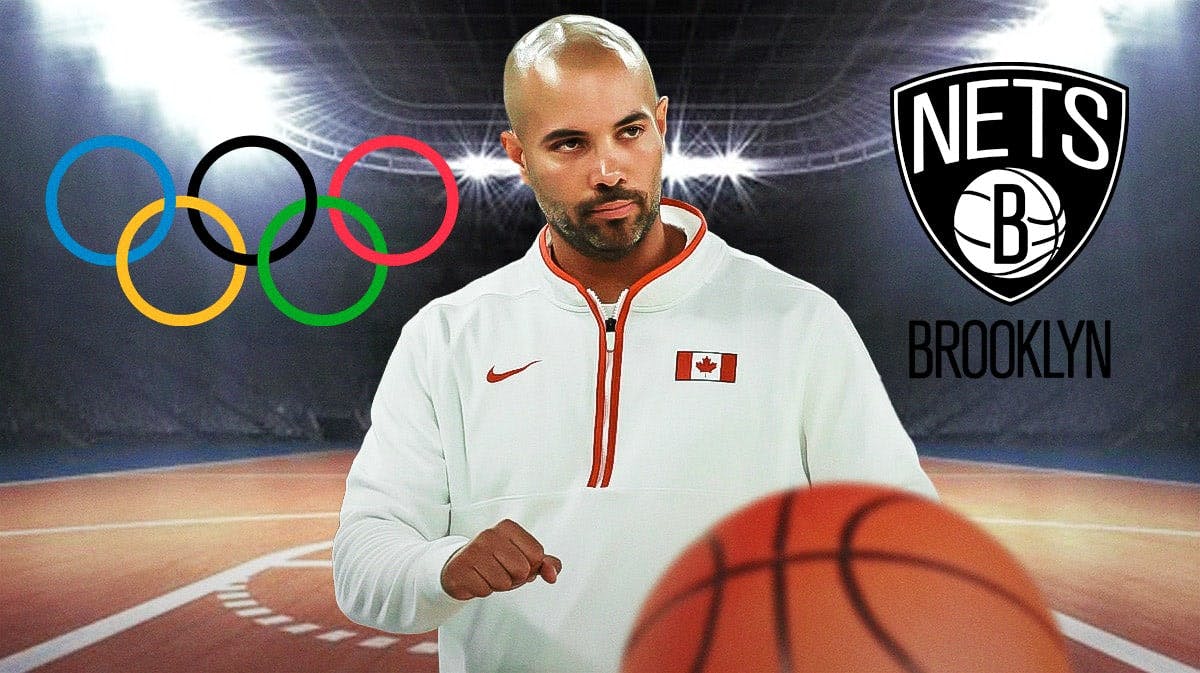 Jordi Fernandez coaching for Team Canada with the olympic rings on one side and a Nets logo on the other.