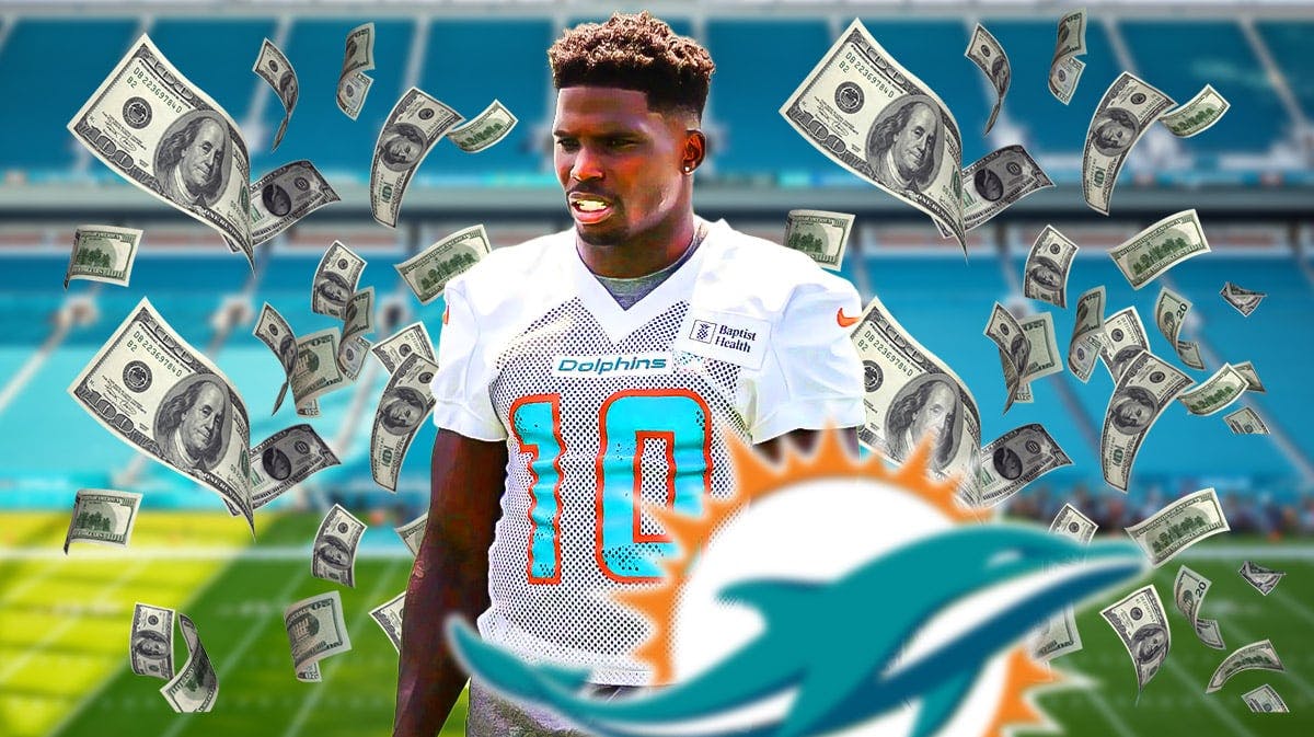 Miami Dolphins star Tyreek Hill with money around him in front of Hard Rock Stadium.
