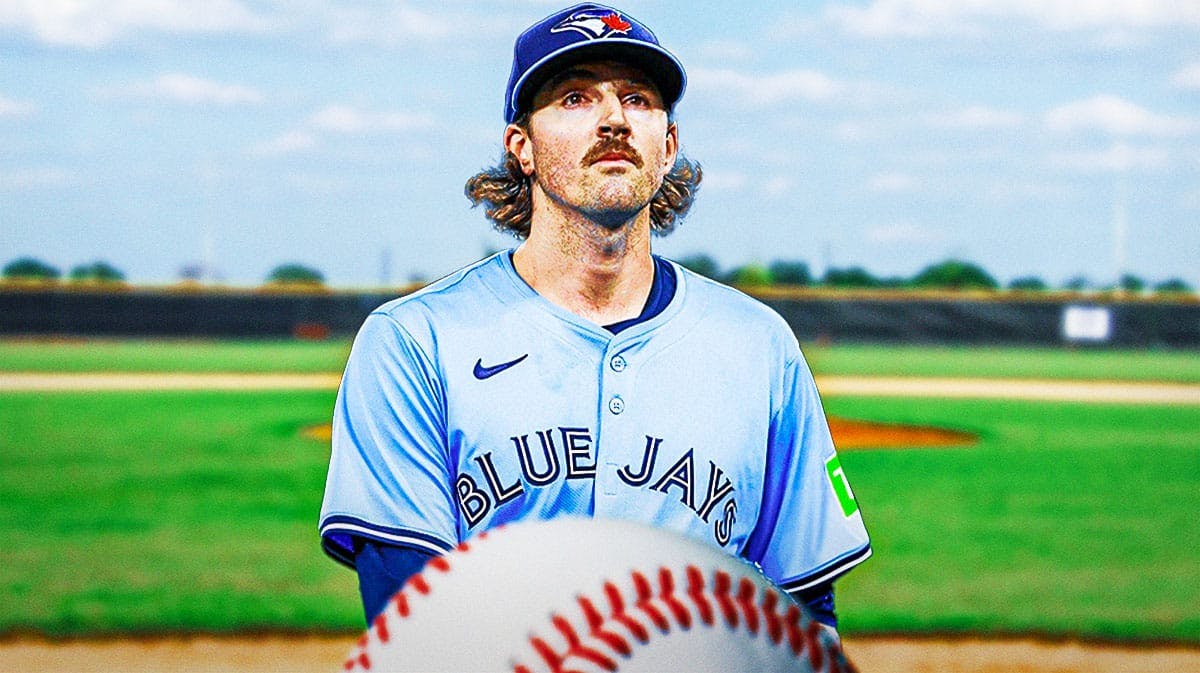 Toronto Blue Jays star Kevin Gausman in front of a baseball field.