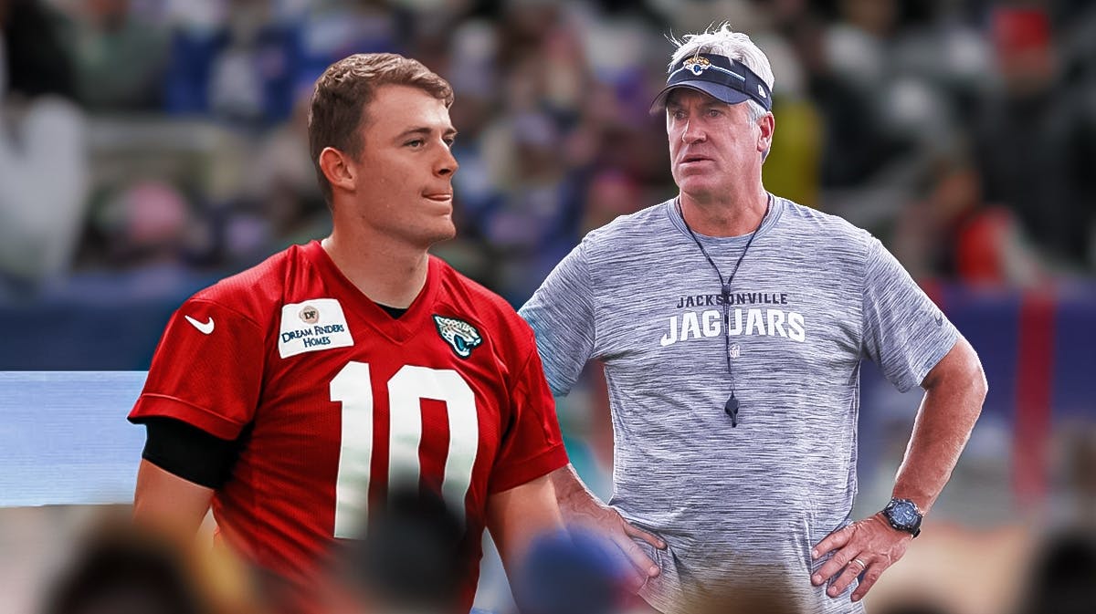 Jaguars quarterback Mac Jones sitting on the football bench in football arena with Jacksonville head coach Doug Pederson standing next to him