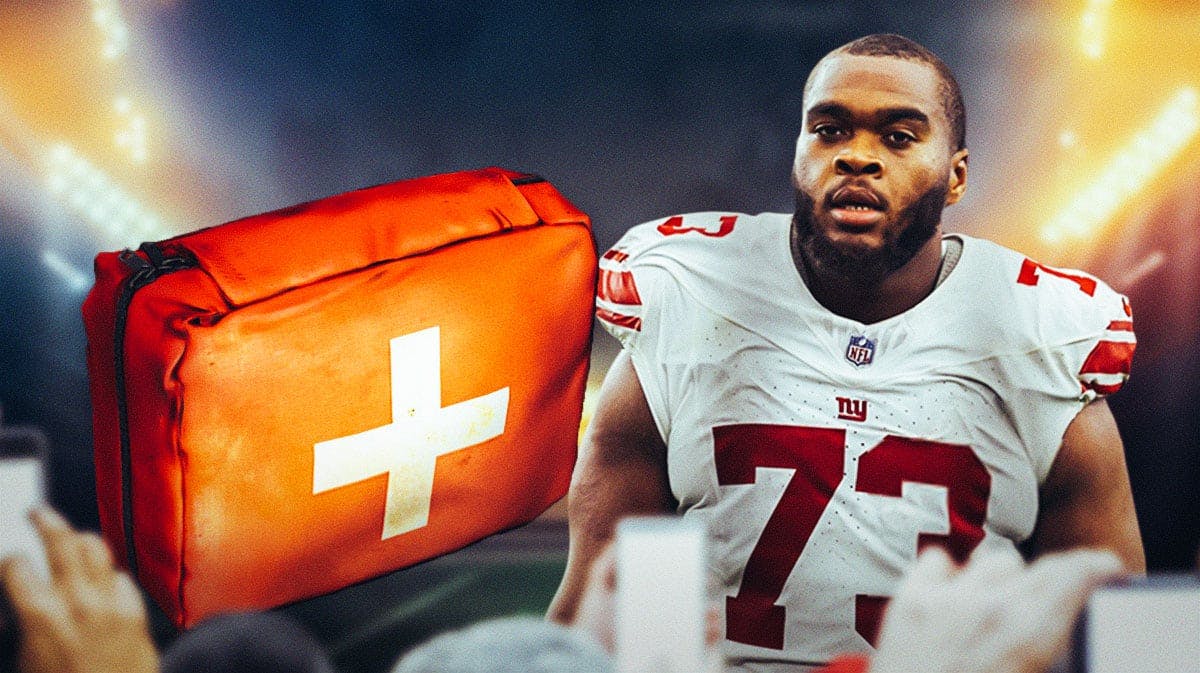 Evan Neal with a first-aid kit next to him with a Giants-themed background.