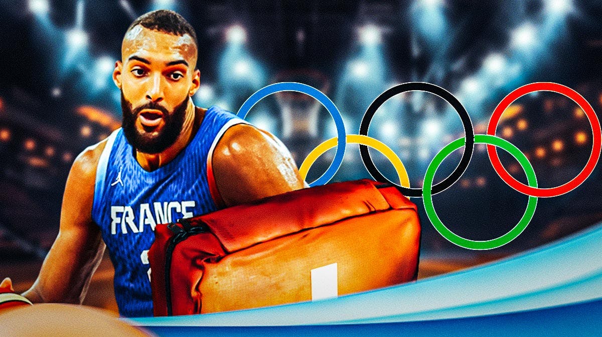 Rudy Gobert in a France uniform. First aid kit near him. Olympics logo in background