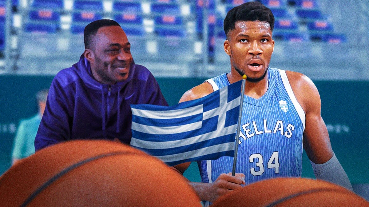 Greece's Giannis Antetokounmpo holding the Greece flag proudly, with his father Charles smiling at him on the side
