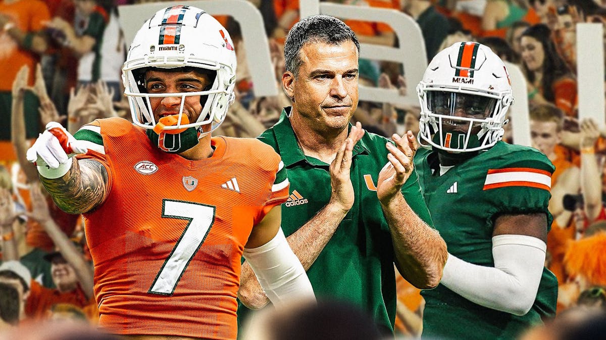 Miami football head coach Mario Cristobal and, Xavier Restrepo, Cam Ward with Miami Hurricanes fans cheering in the background.