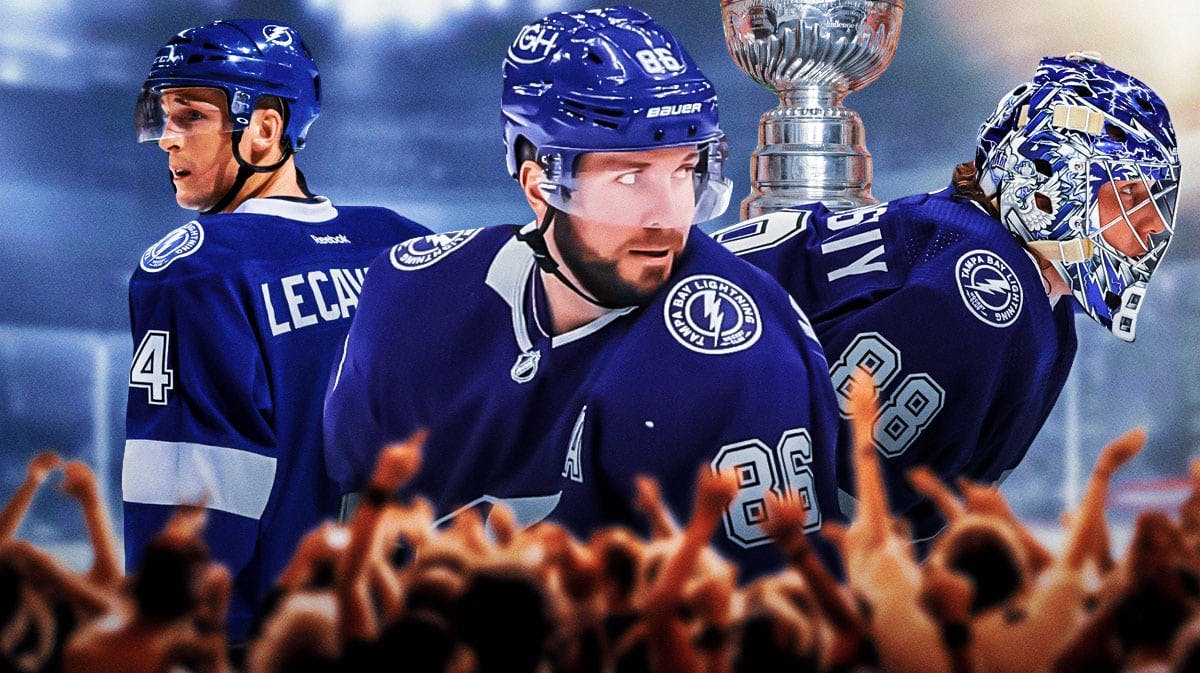 Nikita Kucherov, Andrei vasilevskiy, and Vincent Lecavlier in front of the Stanley Cup.